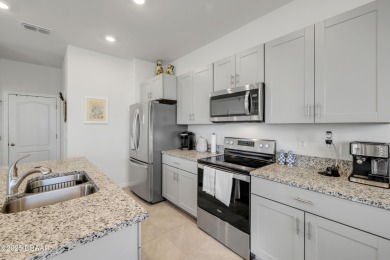 You'll love coming home to this stunning 2023-built waterfront on Venetian Bay Golf Course in Florida - for sale on GolfHomes.com, golf home, golf lot