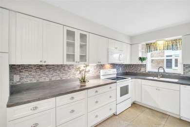 Welcome to this beautifully updated villa in Palm Harbor's on Highland Lakes Executive Golf Course in Florida - for sale on GolfHomes.com, golf home, golf lot