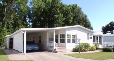 This lovely Palm Harbor home offers a spacious and cozy living on Schalamar Creek Golf and Country Club in Florida - for sale on GolfHomes.com, golf home, golf lot