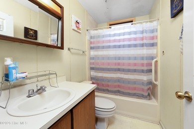 Tucked away on a wooded lot in Fairfield Harbour, this inviting on Harbour Point Golf Club in North Carolina - for sale on GolfHomes.com, golf home, golf lot