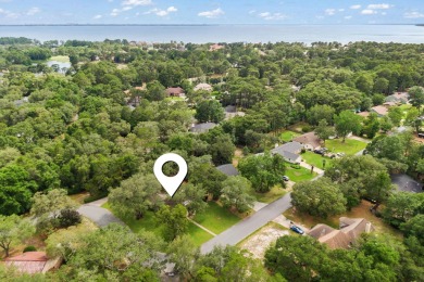 Nestled on a spacious 1/3-acre corner lot backing to a peaceful on Golf Club at Bluewater Bay Resort in Florida - for sale on GolfHomes.com, golf home, golf lot