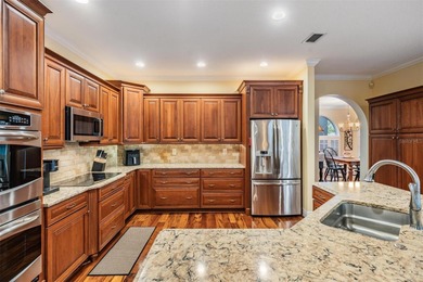 Set on an exceptional oversized wooded corner lot, nearly half on East Lake Woodlands Country Club in Florida - for sale on GolfHomes.com, golf home, golf lot