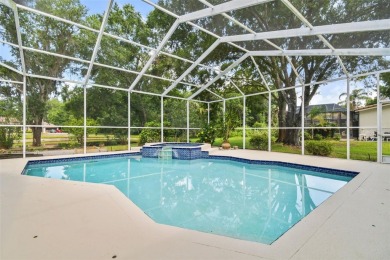Stunning 4-bedroom, 3-bath pool home with spa on a serene pond on Crescent Oaks Country Club in Florida - for sale on GolfHomes.com, golf home, golf lot