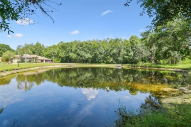 Stunning 4-bedroom, 3-bath pool home with spa on a serene pond on Crescent Oaks Country Club in Florida - for sale on GolfHomes.com, golf home, golf lot