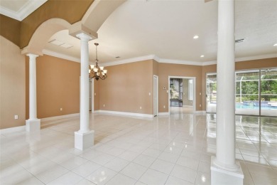 Stunning 4-bedroom, 3-bath pool home with spa on a serene pond on Crescent Oaks Country Club in Florida - for sale on GolfHomes.com, golf home, golf lot