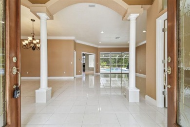 Stunning 4-bedroom, 3-bath pool home with spa on a serene pond on Crescent Oaks Country Club in Florida - for sale on GolfHomes.com, golf home, golf lot