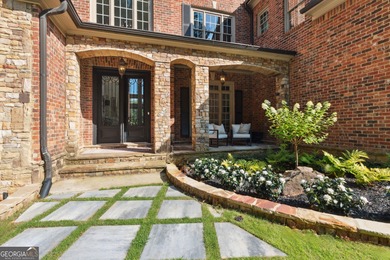 Privately tucked behind a long, tree-lined driveway and greeted on Chateau Elan Golf Club  in Georgia - for sale on GolfHomes.com, golf home, golf lot