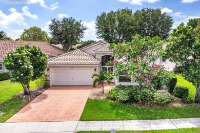 Lakefront single family home nestled amongst vibrant flowering on Westchester Golf and Country Club in Florida - for sale on GolfHomes.com, golf home, golf lot