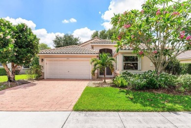 Lakefront single family home nestled amongst vibrant flowering on Westchester Golf and Country Club in Florida - for sale on GolfHomes.com, golf home, golf lot