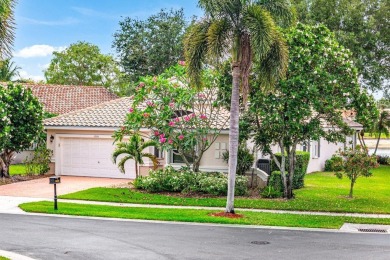 Lakefront single family home nestled amongst vibrant flowering on Westchester Golf and Country Club in Florida - for sale on GolfHomes.com, golf home, golf lot