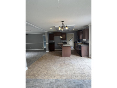 Recently moved to this lot, this beautifully 2015 manufactured on Wildwood Country Club in Florida - for sale on GolfHomes.com, golf home, golf lot