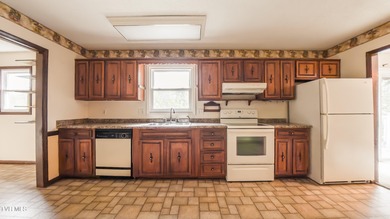 This spacious 4-bedroom, 3-bath home offers incredible potential on Country Club of Bristol in Tennessee - for sale on GolfHomes.com, golf home, golf lot
