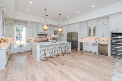 Poised along the water's edge in the prestigious Reunion Golf on Reunion Golf Club in Mississippi - for sale on GolfHomes.com, golf home, golf lot