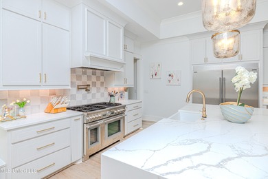 Poised along the water's edge in the prestigious Reunion Golf on Reunion Golf Club in Mississippi - for sale on GolfHomes.com, golf home, golf lot