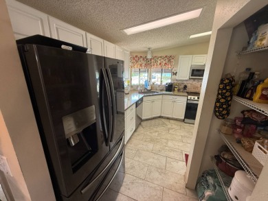 This well-cared for Palm Harbor home is being sold fully on Del Tura Golf and Country Club in Florida - for sale on GolfHomes.com, golf home, golf lot