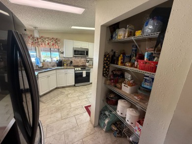 This well-cared for Palm Harbor home is being sold fully on Del Tura Golf and Country Club in Florida - for sale on GolfHomes.com, golf home, golf lot