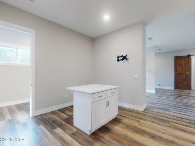 Country living meets modern convenience in this serene wooded on New Smyrna Beach Golf Course in Florida - for sale on GolfHomes.com, golf home, golf lot