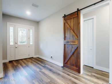 Country living meets modern convenience in this serene wooded on New Smyrna Beach Golf Course in Florida - for sale on GolfHomes.com, golf home, golf lot