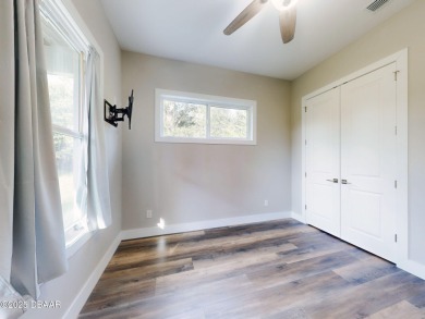Country living meets modern convenience in this serene wooded on New Smyrna Beach Golf Course in Florida - for sale on GolfHomes.com, golf home, golf lot