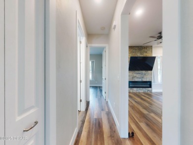 Country living meets modern convenience in this serene wooded on New Smyrna Beach Golf Course in Florida - for sale on GolfHomes.com, golf home, golf lot