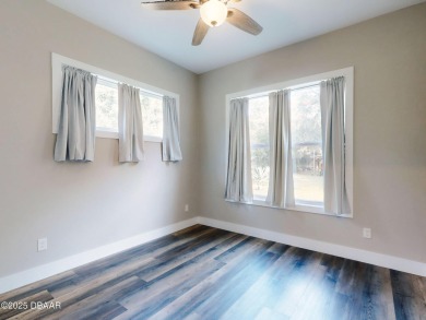 Country living meets modern convenience in this serene wooded on New Smyrna Beach Golf Course in Florida - for sale on GolfHomes.com, golf home, golf lot