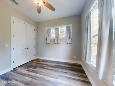 Country living meets modern convenience in this serene wooded on New Smyrna Beach Golf Course in Florida - for sale on GolfHomes.com, golf home, golf lot