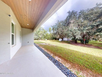 Country living meets modern convenience in this serene wooded on New Smyrna Beach Golf Course in Florida - for sale on GolfHomes.com, golf home, golf lot