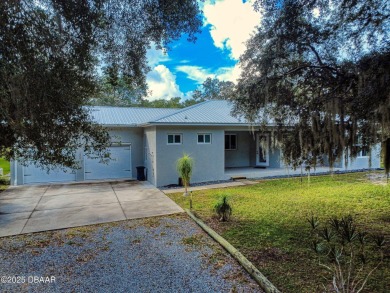 Country living meets modern convenience in this serene wooded on New Smyrna Beach Golf Course in Florida - for sale on GolfHomes.com, golf home, golf lot