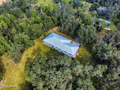 Country living meets modern convenience in this serene wooded on New Smyrna Beach Golf Course in Florida - for sale on GolfHomes.com, golf home, golf lot