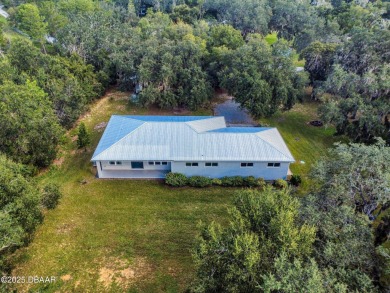 Country living meets modern convenience in this serene wooded on New Smyrna Beach Golf Course in Florida - for sale on GolfHomes.com, golf home, golf lot