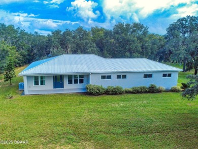 Country living meets modern convenience in this serene wooded on New Smyrna Beach Golf Course in Florida - for sale on GolfHomes.com, golf home, golf lot