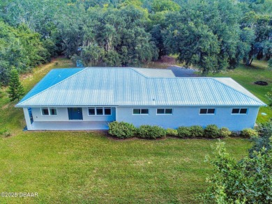 Country living meets modern convenience in this serene wooded on New Smyrna Beach Golf Course in Florida - for sale on GolfHomes.com, golf home, golf lot
