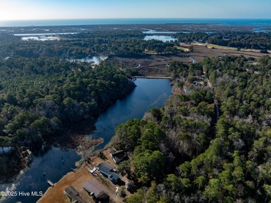 Just under an acre of waterfront property in the Sunset Lakes on Oyster Bay Golf Links in North Carolina - for sale on GolfHomes.com, golf home, golf lot