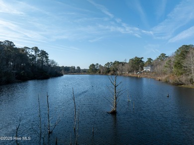 Just under an acre of waterfront property in the Sunset Lakes on Oyster Bay Golf Links in North Carolina - for sale on GolfHomes.com, golf home, golf lot
