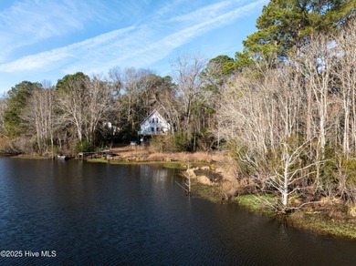 Just under an acre of waterfront property in the Sunset Lakes on Oyster Bay Golf Links in North Carolina - for sale on GolfHomes.com, golf home, golf lot