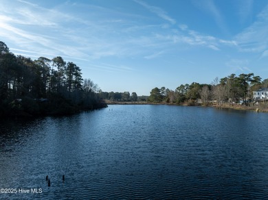 Just under an acre of waterfront property in the Sunset Lakes on Oyster Bay Golf Links in North Carolina - for sale on GolfHomes.com, golf home, golf lot
