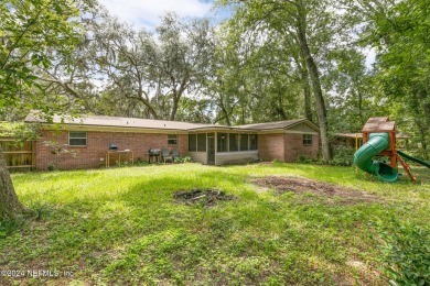 Nestled within a canopy of lush trees, this charming 1960s home on Blue Cypress Golf Club in Florida - for sale on GolfHomes.com, golf home, golf lot