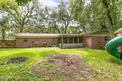 Nestled within a canopy of lush trees, this charming 1960s home on Blue Cypress Golf Club in Florida - for sale on GolfHomes.com, golf home, golf lot