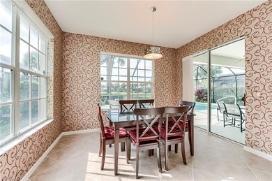 This stunning home features a spacious screened lanai with south on Shadow Wood Country Club in Florida - for sale on GolfHomes.com, golf home, golf lot