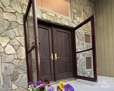 Beautiful resort home on 2.4 private wooded acres within minutes on Rumbling Bald Resort on Lake Lure in North Carolina - for sale on GolfHomes.com, golf home, golf lot