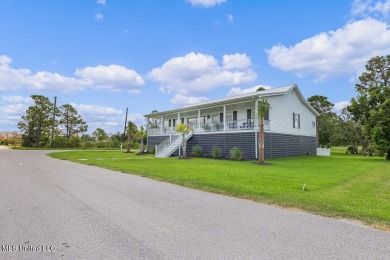 Welcome to 129 Sweet Bay Dr., a stunning coastal retreat nestled on Pass Christian Isles Golf Club in Mississippi - for sale on GolfHomes.com, golf home, golf lot