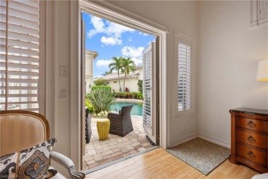 This magnificent two-story courtyard style home features 4BR, 4 on Pelican Marsh Golf Club in Florida - for sale on GolfHomes.com, golf home, golf lot