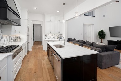 Experience elevated living with picturesque lake views from on The Tribute At the Colony in Texas - for sale on GolfHomes.com, golf home, golf lot