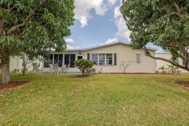 Enjoy peaceful water views and your own Mango Tree from this on Savanna Golf Club in Florida - for sale on GolfHomes.com, golf home, golf lot