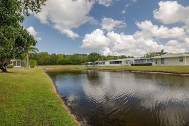 Enjoy peaceful water views and your own Mango Tree from this on Savanna Golf Club in Florida - for sale on GolfHomes.com, golf home, golf lot