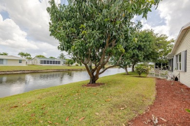 Enjoy peaceful water views and your own Mango Tree from this on Savanna Golf Club in Florida - for sale on GolfHomes.com, golf home, golf lot