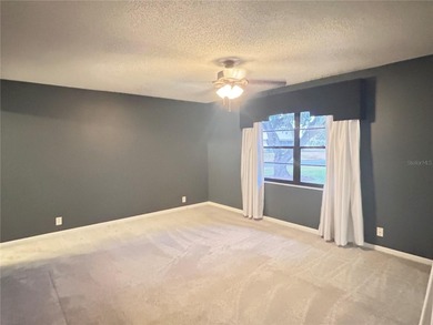 MOVE IN CONDITION!  Nestled on a beautifully landscaped and tree on Cypresswood Golf and Country Club in Florida - for sale on GolfHomes.com, golf home, golf lot