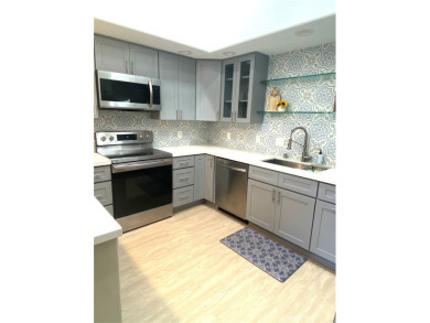 Gorgeous corner drive-up unit adorned with lovely exterior tile on Leisure World Seal Beach Golf Course in California - for sale on GolfHomes.com, golf home, golf lot