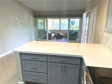 Gorgeous corner drive-up unit adorned with lovely exterior tile on Leisure World Seal Beach Golf Course in California - for sale on GolfHomes.com, golf home, golf lot