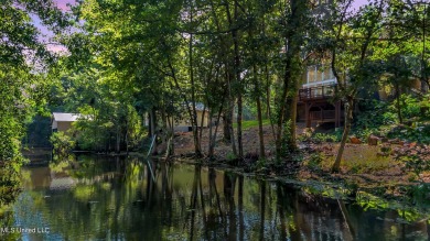 Welcome to your unique Dutch Colonial-style waterfront oasis in on Mississippi National Golf Course in Mississippi - for sale on GolfHomes.com, golf home, golf lot